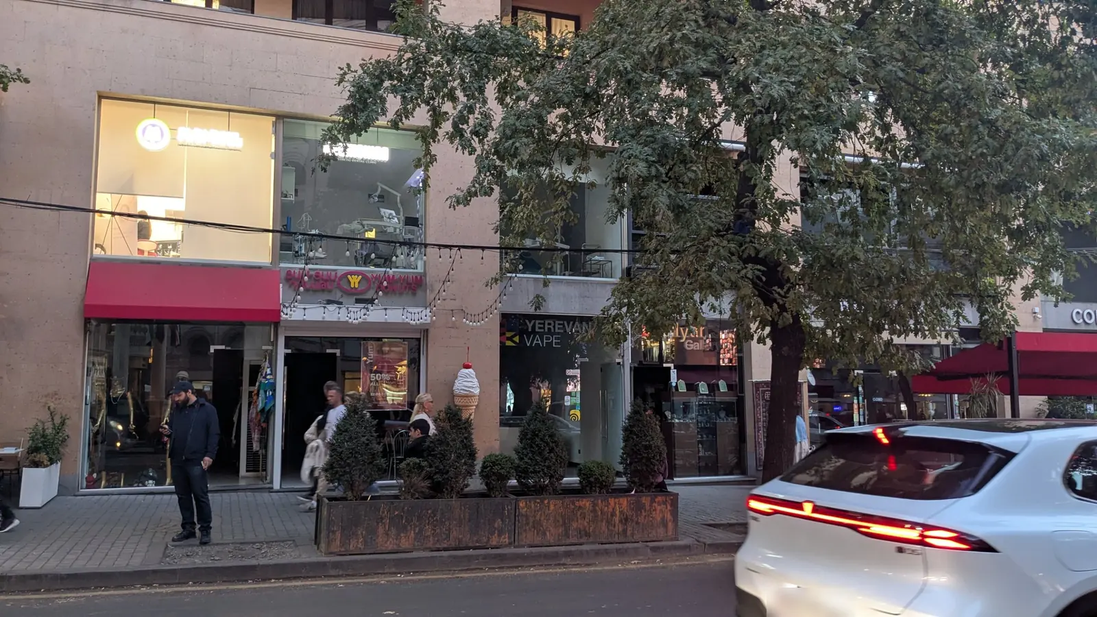 Shop and café windows along a street in central Yerevan, October 8, 2026